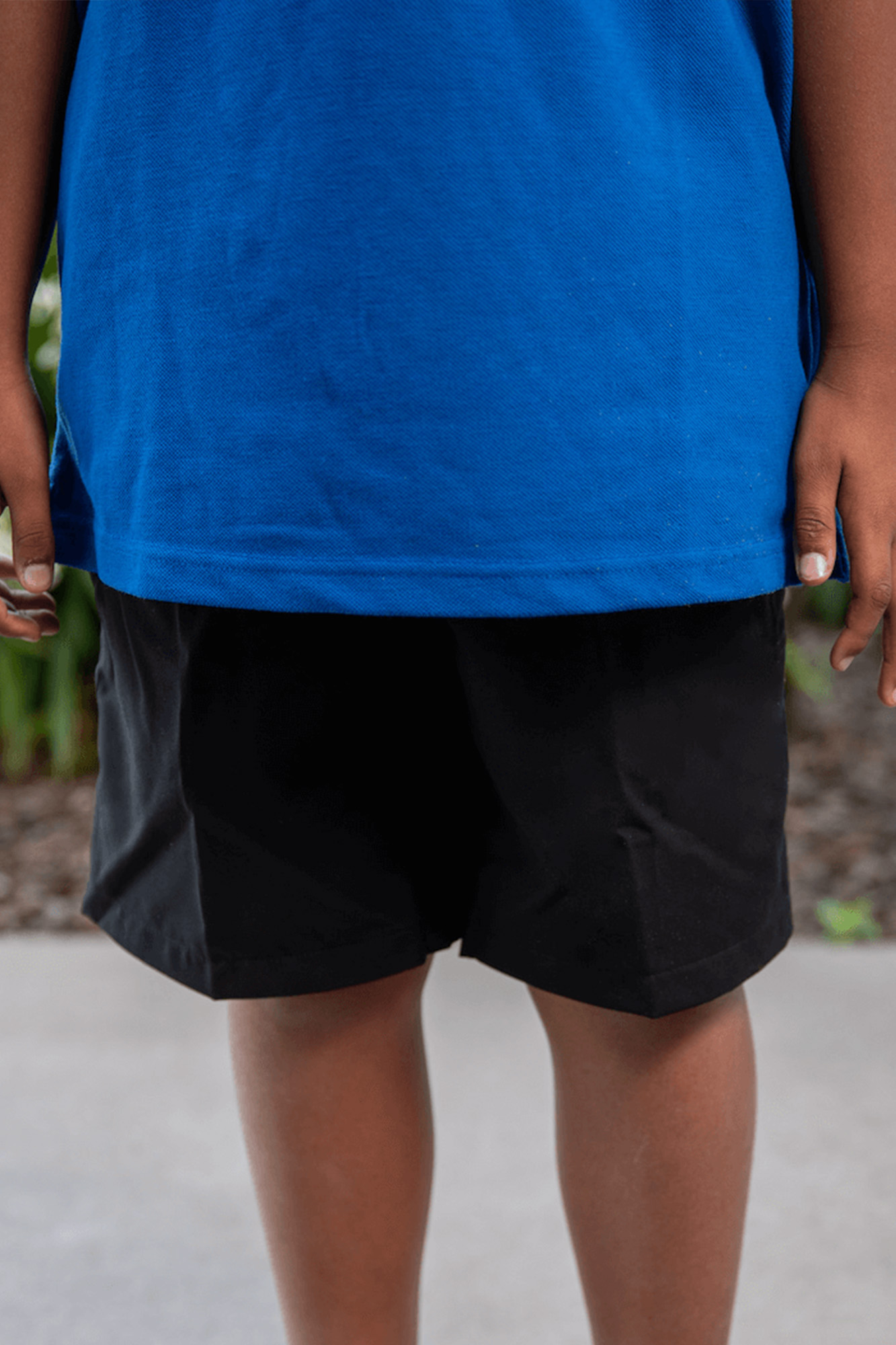 child wearing black shorts and blue shirt